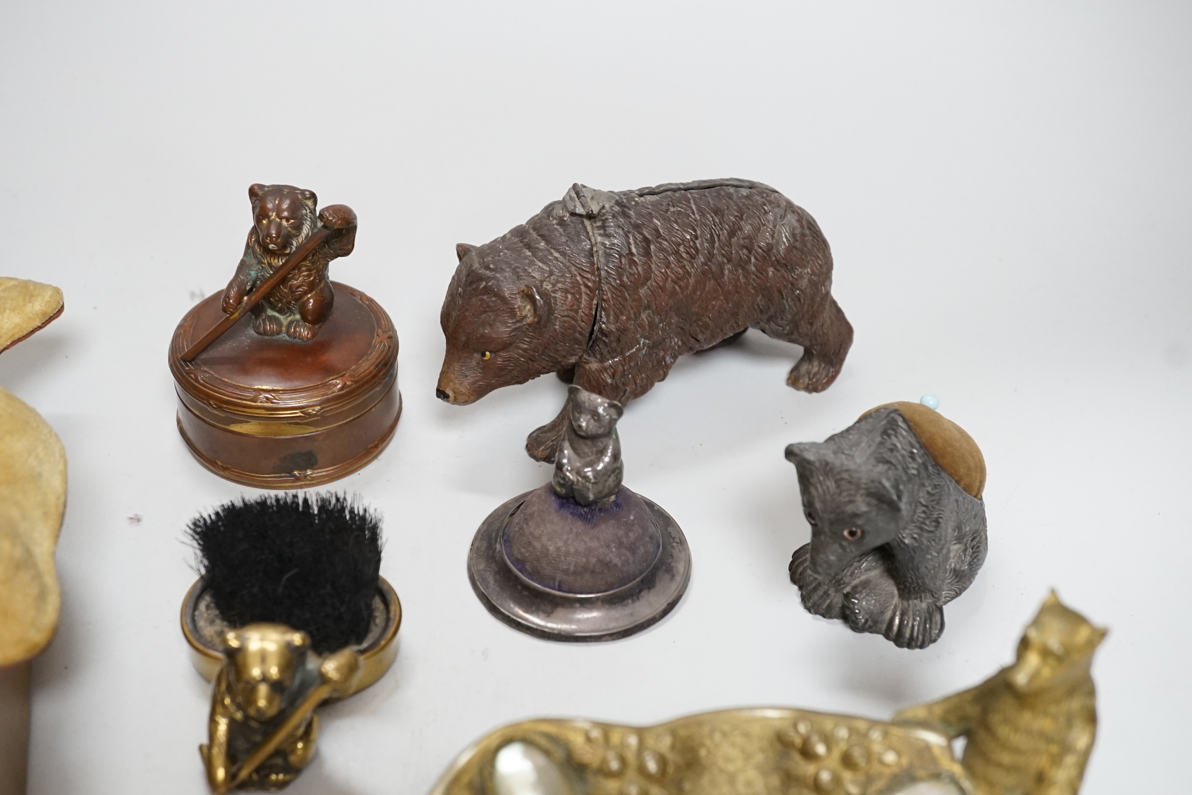 Four metal bear pin cushions, a money box, a bear stud box, three metal bears, a mother of pearl metal bear dish and an advertising bear on a box